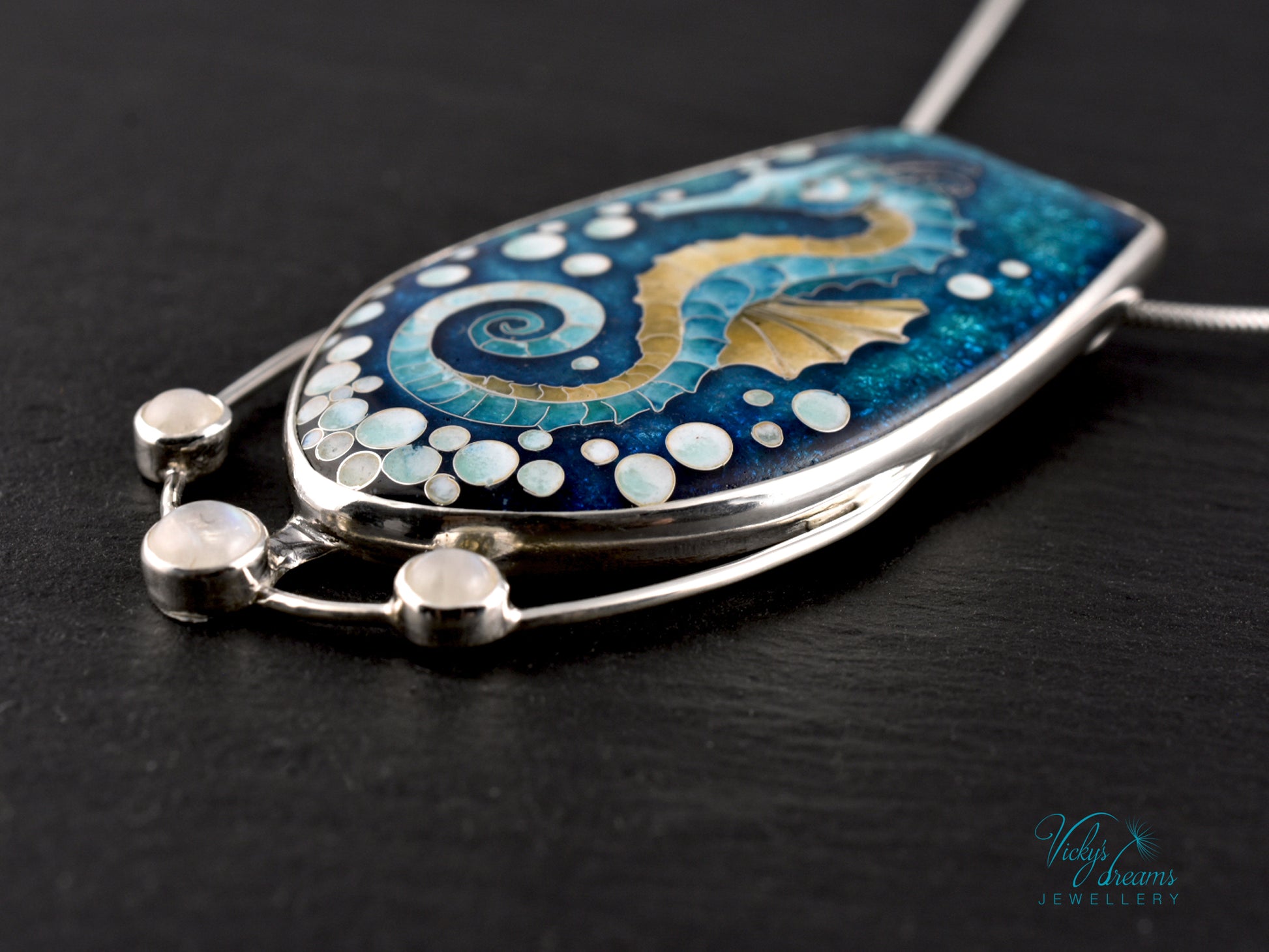Handcrafted cloisonné seahorse pendant with vibrant enamel colors and rainbow moonstones
