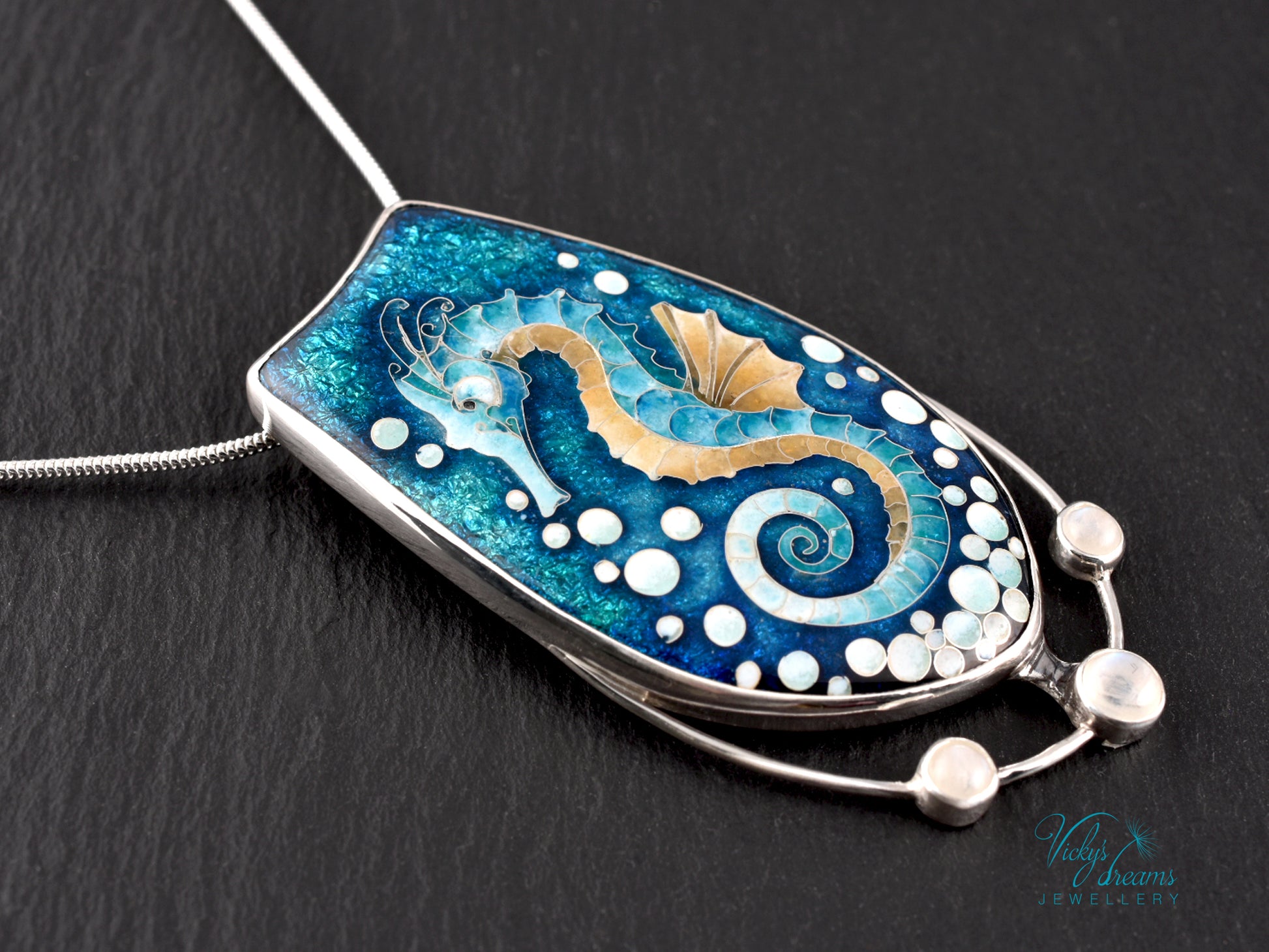 Handcrafted cloisonné seahorse pendant with vibrant enamel colors and rainbow moonstones