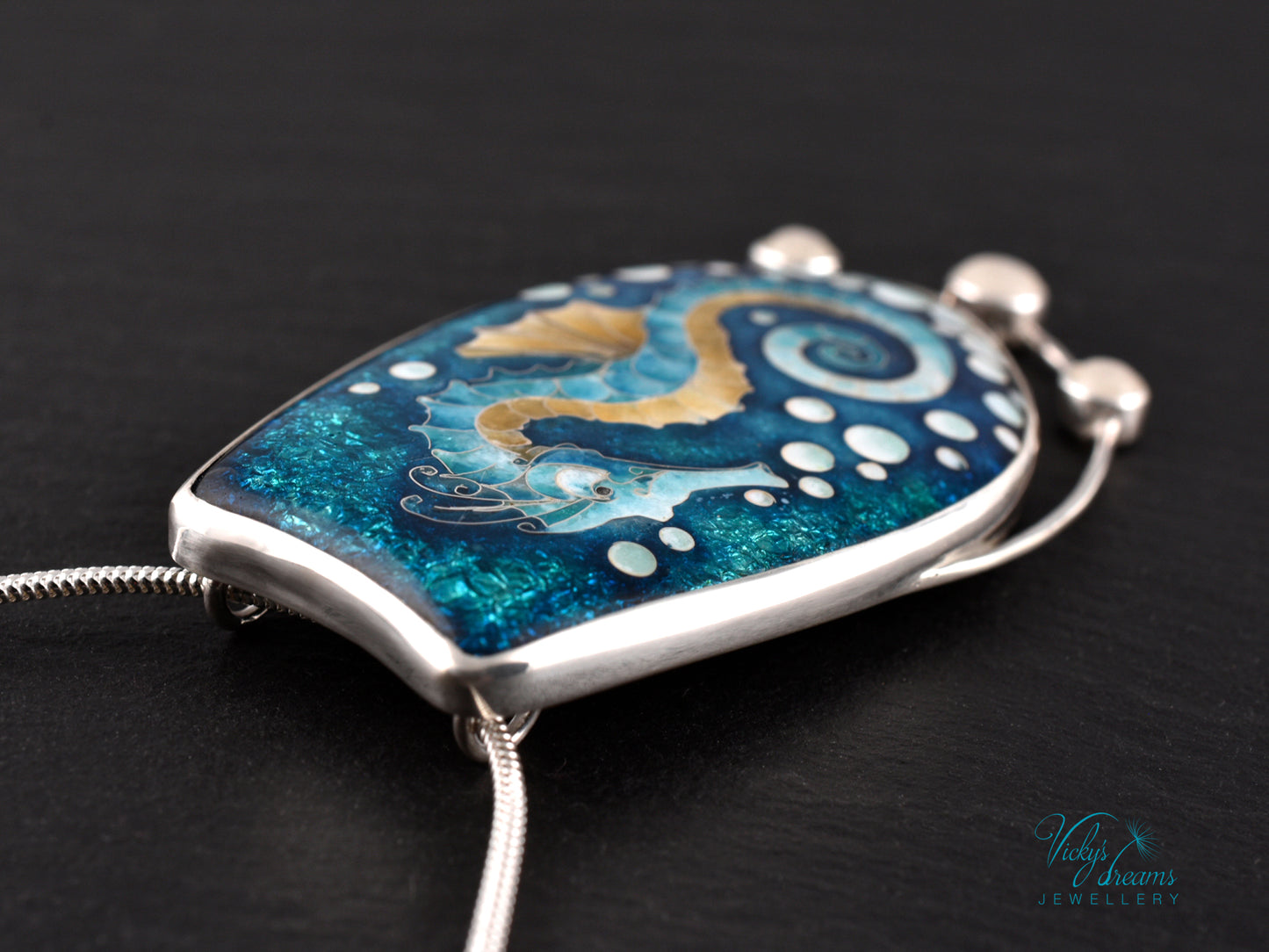 Handcrafted cloisonné seahorse pendant with vibrant enamel colors and rainbow moonstones
