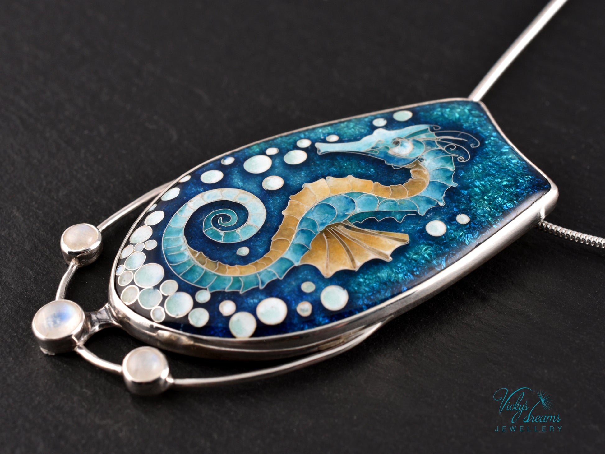 Handcrafted cloisonné seahorse pendant with vibrant enamel colors and rainbow moonstones