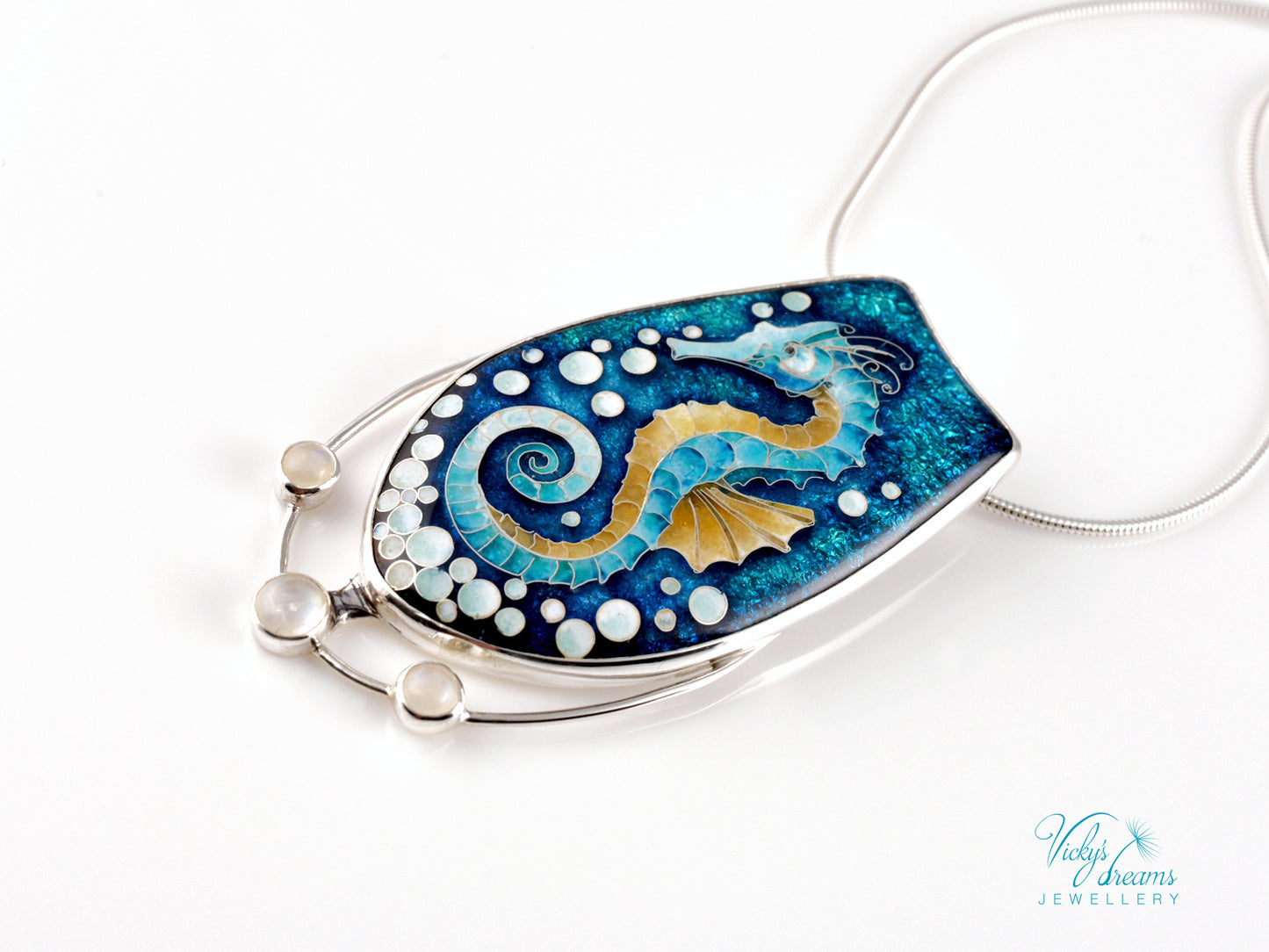 Handcrafted cloisonné seahorse pendant with vibrant enamel colors and rainbow moonstones