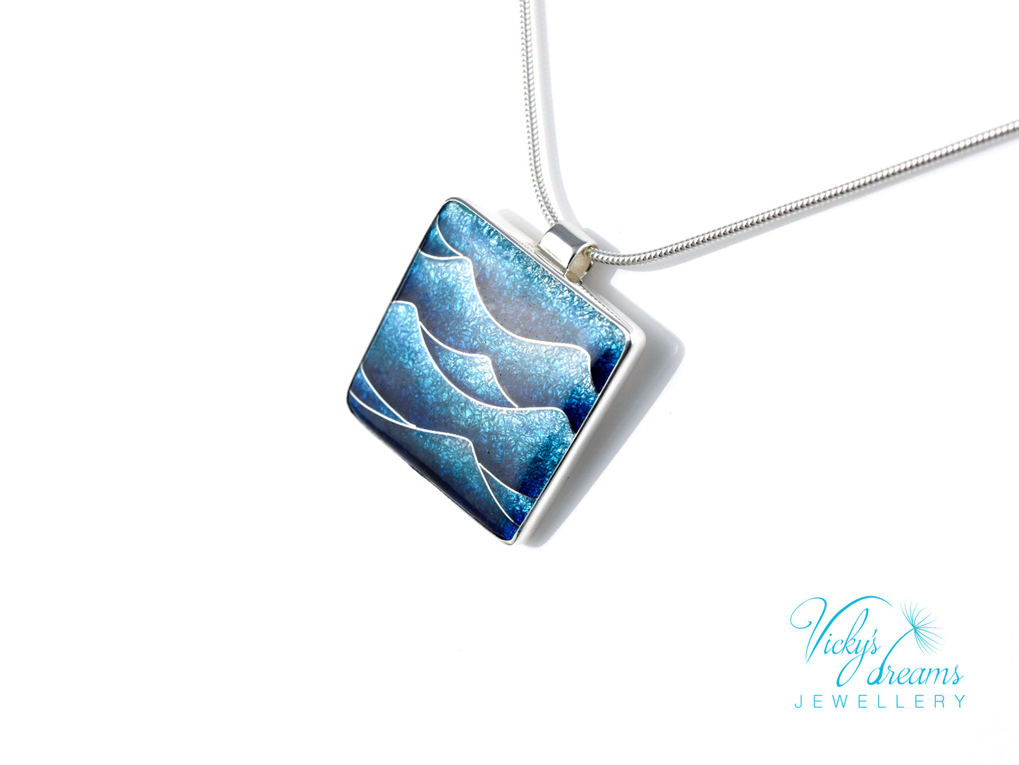 Bright blue cloisonné enamel necklace featuring ocean waves, set in sterling silver