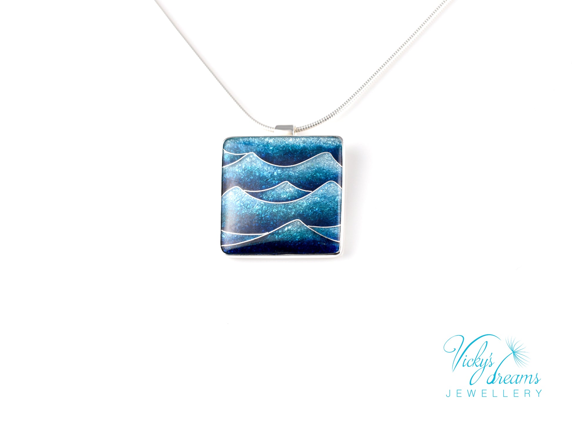 Bright blue cloisonné enamel necklace featuring ocean waves, set in sterling silver