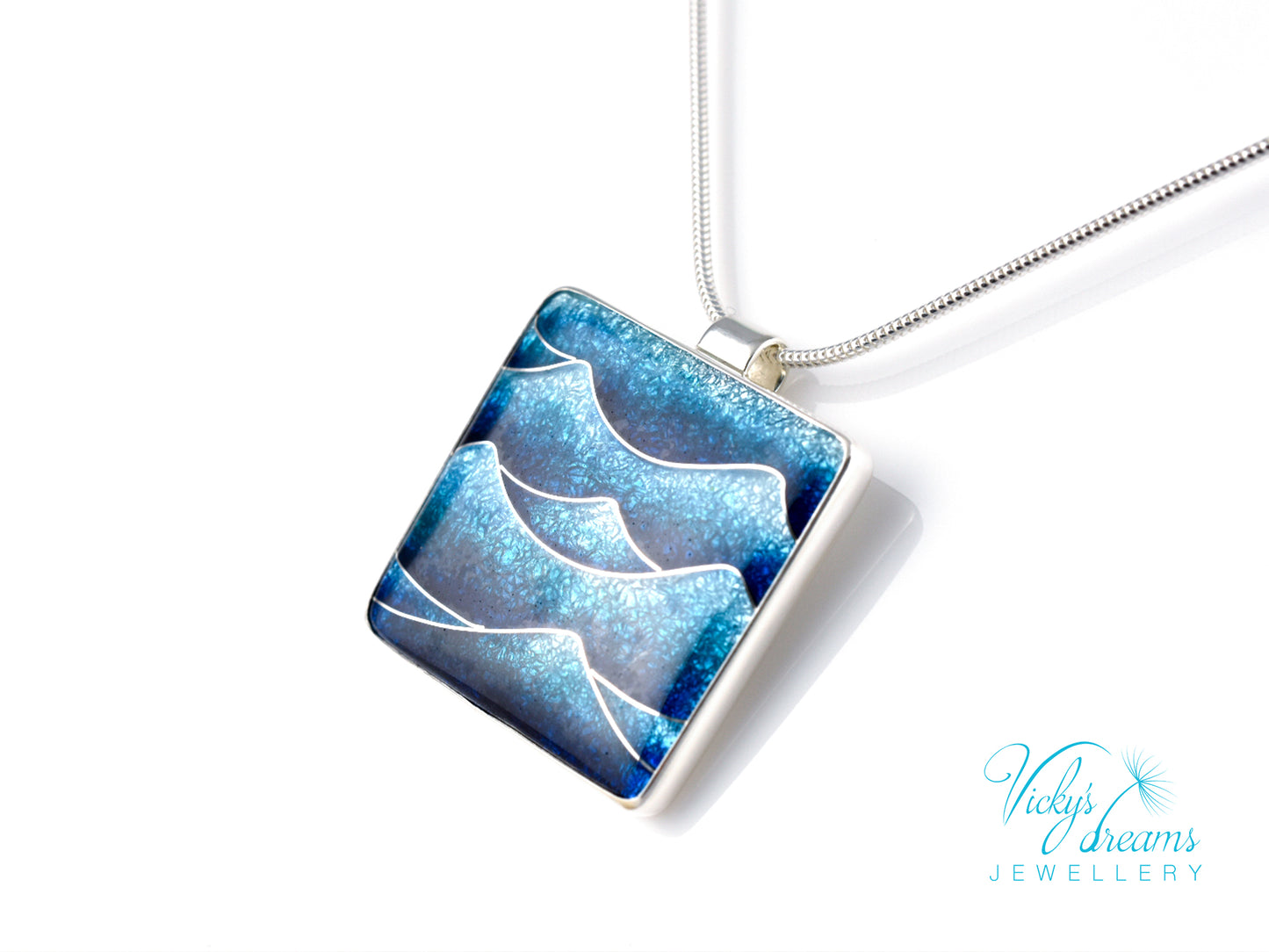 Bright blue cloisonné enamel necklace featuring ocean waves, set in sterling silver