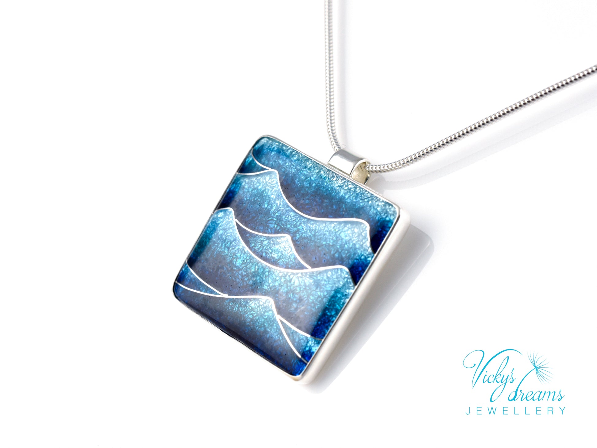 Bright blue cloisonné enamel necklace featuring ocean waves, set in sterling silver