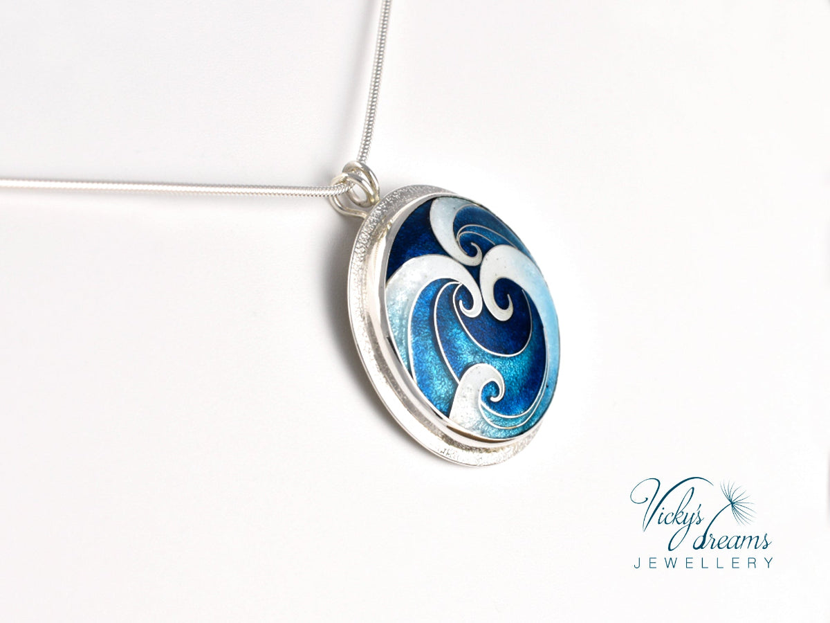 cloisonne pendant with blue and white wave design branded 'Vicky's Dreams Jewellery'.