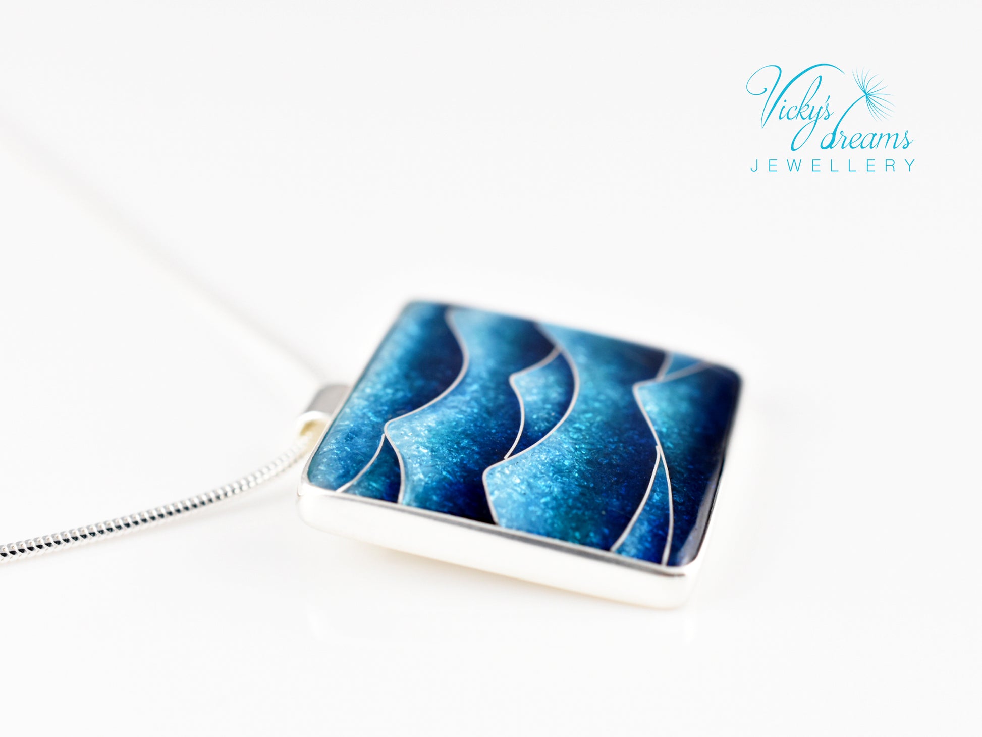 Bright blue cloisonné enamel necklace featuring ocean waves, set in sterling silver