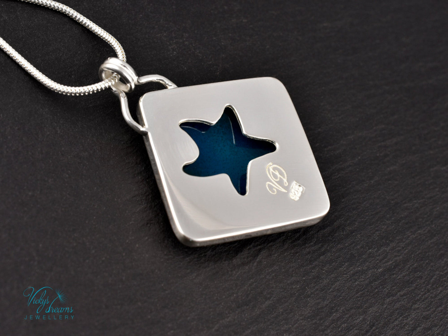 Handmade cloisonné enamel starfish pendant in ocean blue and ivory, set in sterling silver