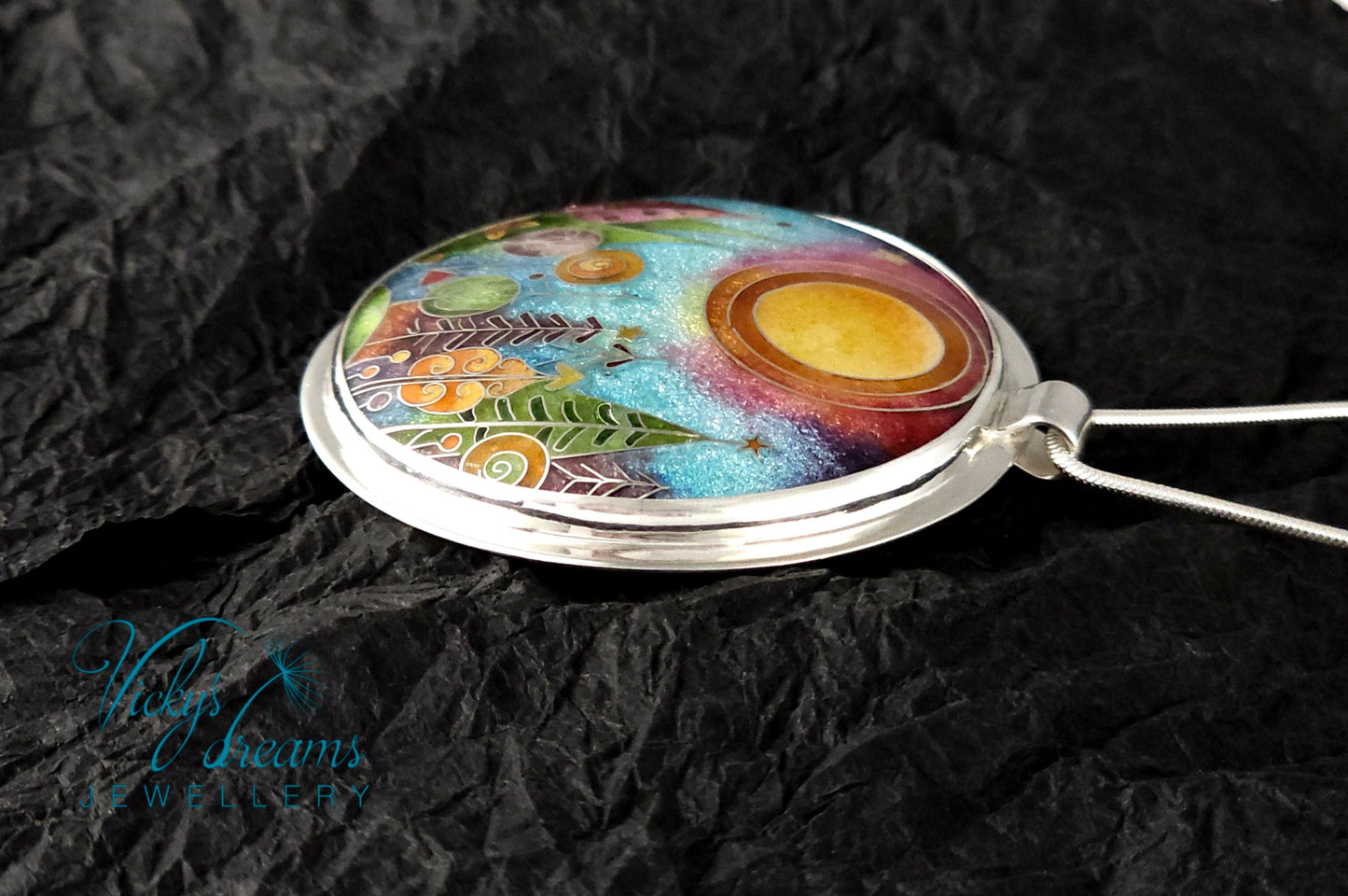Handmade sterling silver cloisonné enamel pendant featuring a dreamlike forest with stylized trees, flowing lines, spiral motifs, and subtle stars