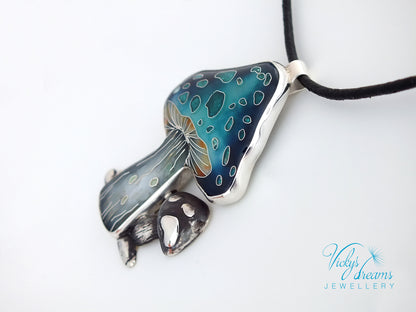 Jewelry pendant with blue and silver design on a white background
