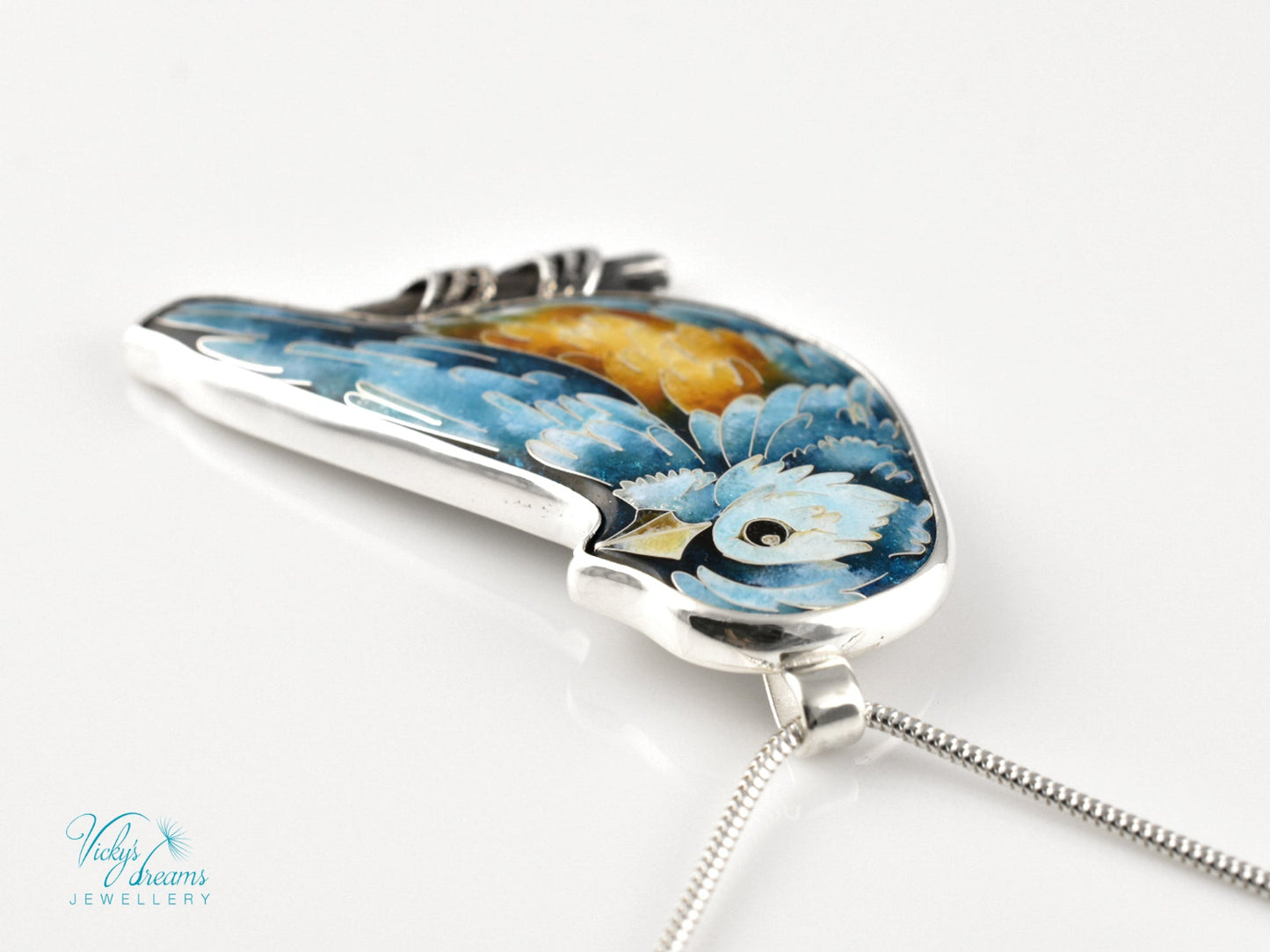 Bird-shaped pendant with blue and orange feathers 