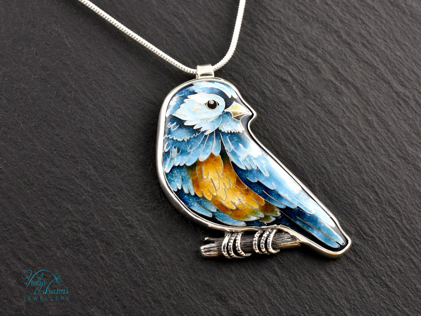 Bird-shaped pendant with blue and orange feathers 