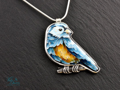 Bird-shaped pendant with blue and orange feathers 