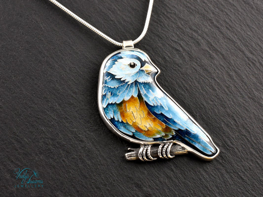 Bird-shaped pendant with blue and orange feathers 