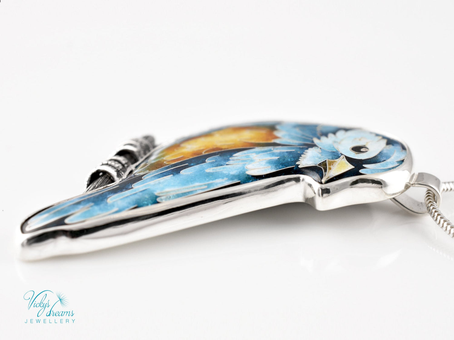 Bird-shaped pendant with blue and orange feathers 