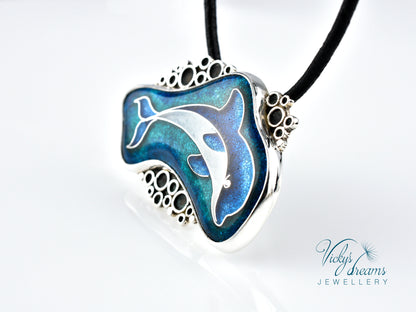 Dolphin-shaped pendant on a black cord with 'Vicky's Dreams Jewellery' branding.