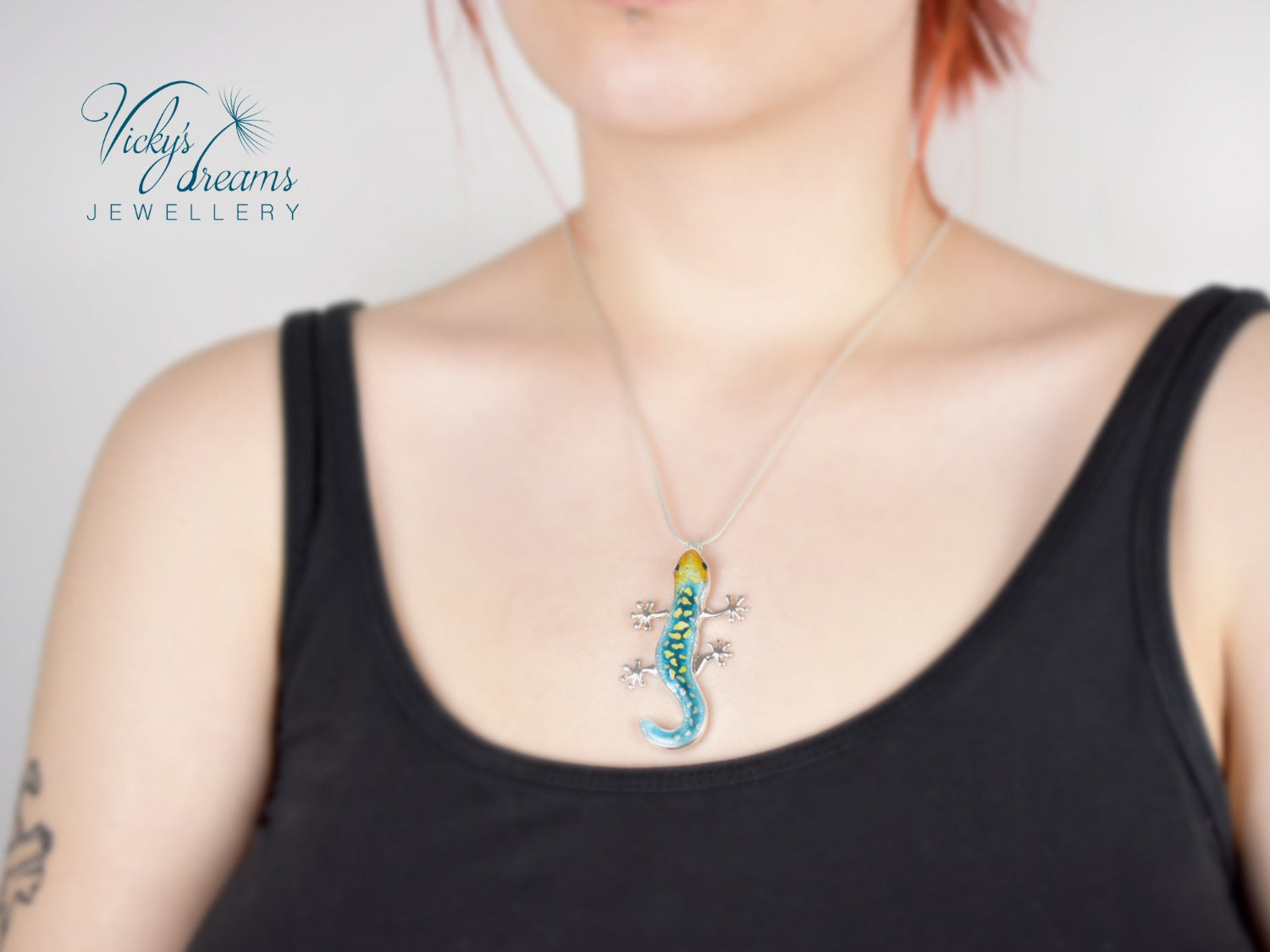 Handcrafted cloisonné enamel necklace with blue, yellow, and orange lizard design set in sterling silver.