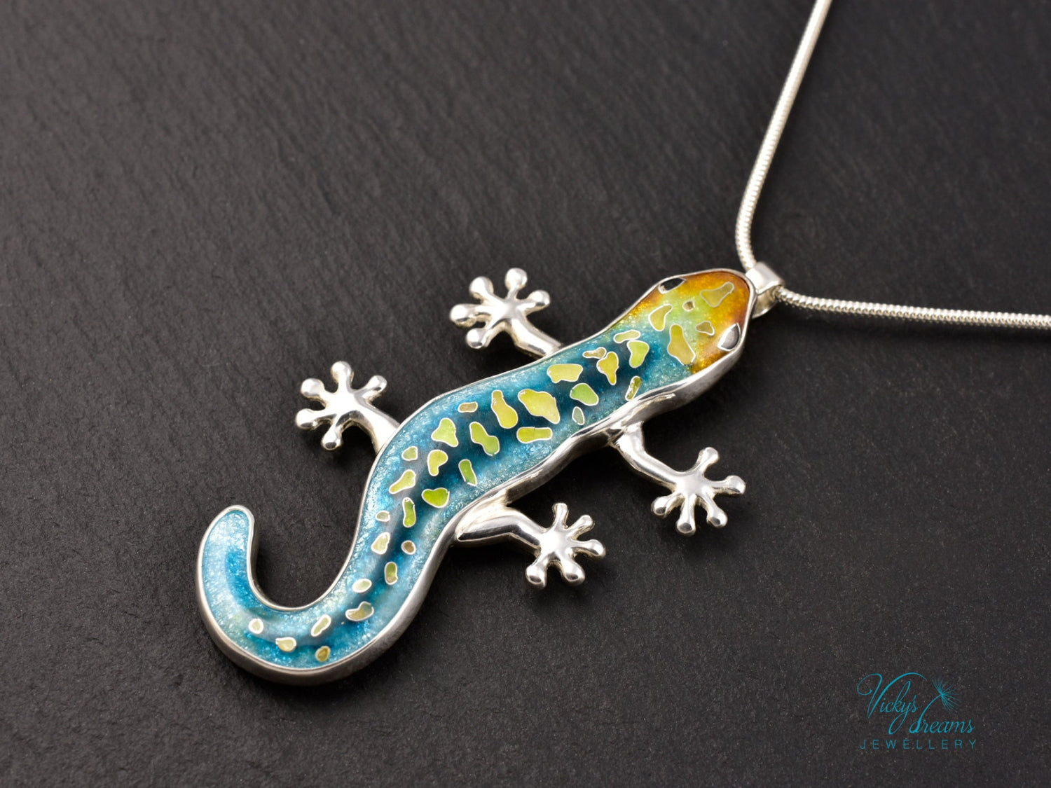 Handcrafted cloisonné enamel necklace with blue, yellow, and orange lizard design set in sterling silver.