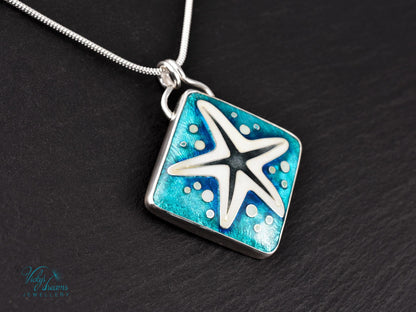 Handmade cloisonné enamel starfish pendant in ocean blue and ivory, set in sterling silver