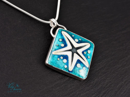 Handmade cloisonné enamel starfish pendant in ocean blue and ivory, set in sterling silver