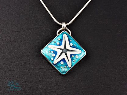 Handmade cloisonné enamel starfish pendant in ocean blue and ivory, set in sterling silver