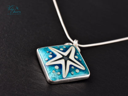 Handmade cloisonné enamel starfish pendant in ocean blue and ivory, set in sterling silver