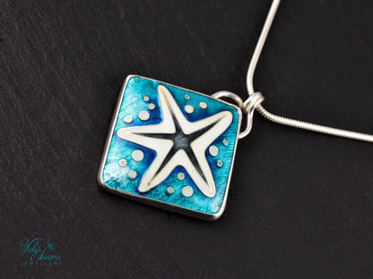 Handmade cloisonné enamel starfish pendant in ocean blue and ivory, set in sterling silver