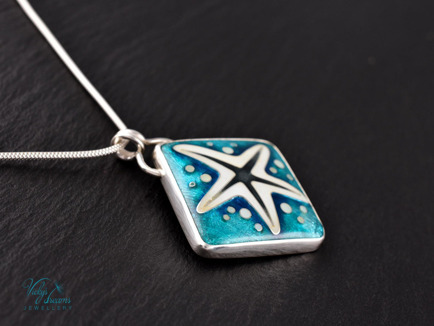 Handmade cloisonné enamel starfish pendant in ocean blue and ivory, set in sterling silver