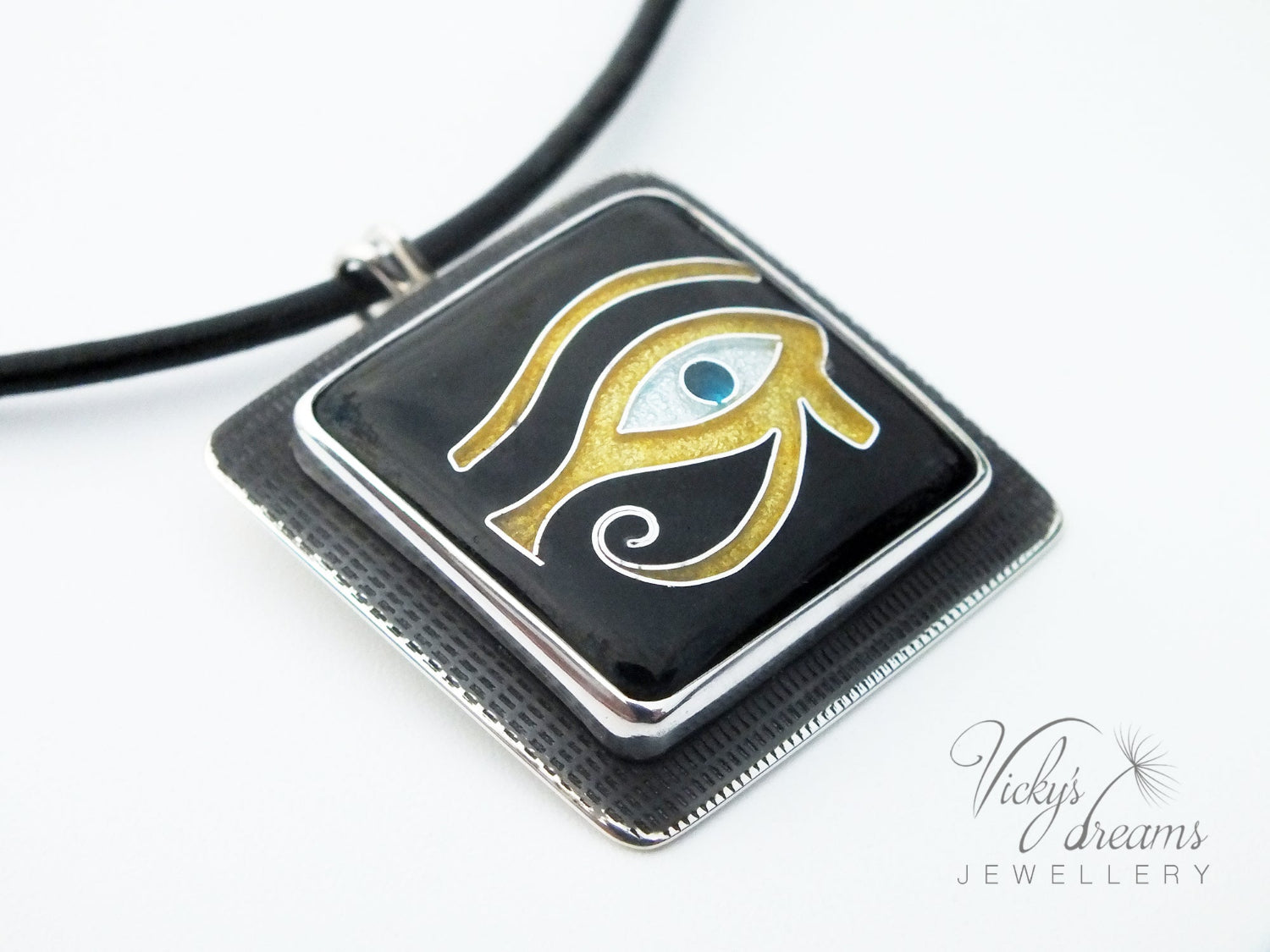 Handmade Egyptian cloisonné enamel Horus Eye pendant in black, gold, and blue set in oxidised sterling silver