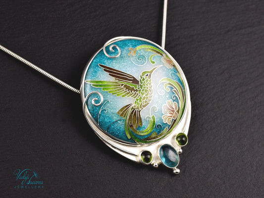 Handcrafted hummingbird pendant with cloisonné enamel and gemstone accents