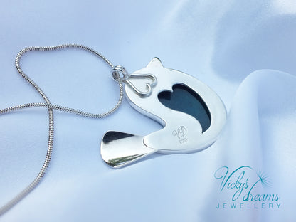 Silver pendant with a heart design on a light blue satin background, branded 'Vicky's Dreams Jewellery'.