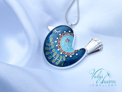 Decorative pendant on a chain with intricate design, featuring the brand 'Vicky's Dreams Jewellery'.
