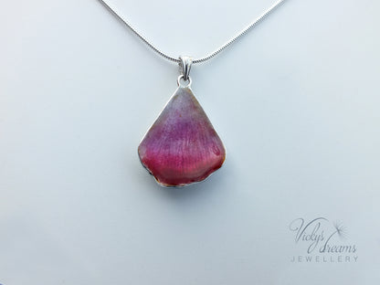 Pink flower petal pendant worn on sterling silver necklace