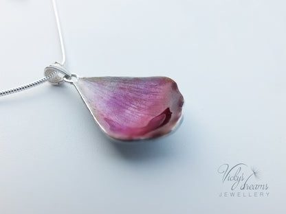 Pink flower petal pendant worn on sterling silver necklace