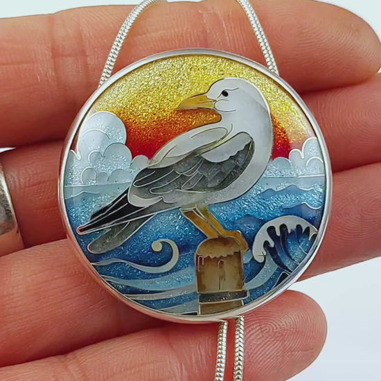 Handmade cloisonné seagull pendant necklace with sunset background