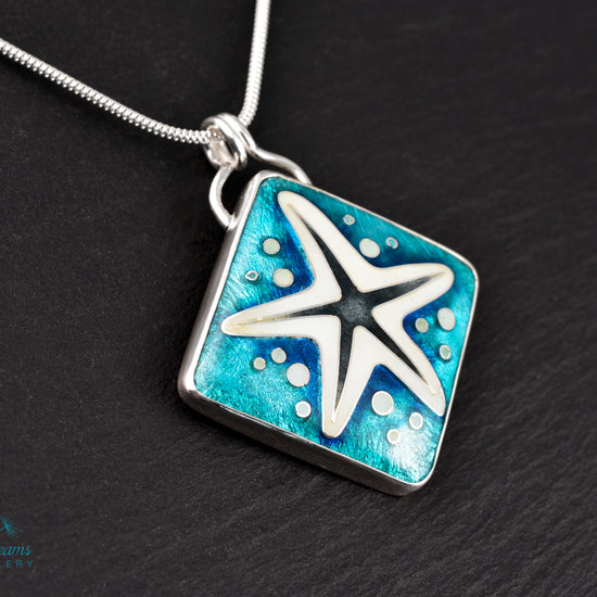 Handmade cloisonné enamel starfish pendant in ocean blue and ivory, set in sterling silver