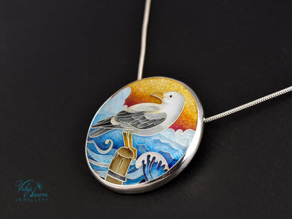 Handmade cloisonné seagull pendant necklace with sunset background