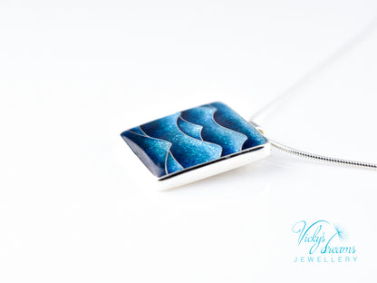 Bright blue cloisonné enamel necklace featuring ocean waves, set in sterling silver
