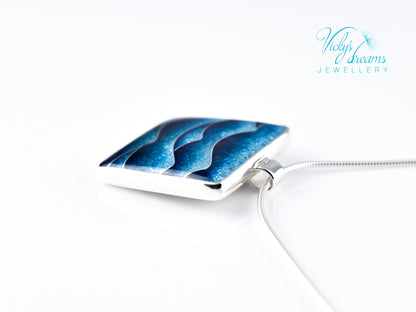 Bright blue cloisonné enamel necklace featuring ocean waves, set in sterling silver
