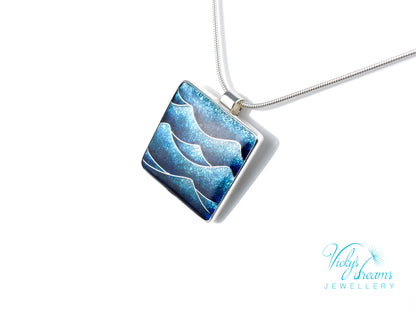 Bright blue cloisonné enamel necklace featuring ocean waves, set in sterling silver

