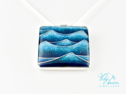 Bright blue cloisonné enamel necklace featuring ocean waves, set in sterling silver
