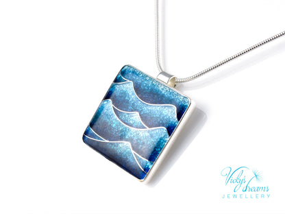 Bright blue cloisonné enamel necklace featuring ocean waves, set in sterling silver
