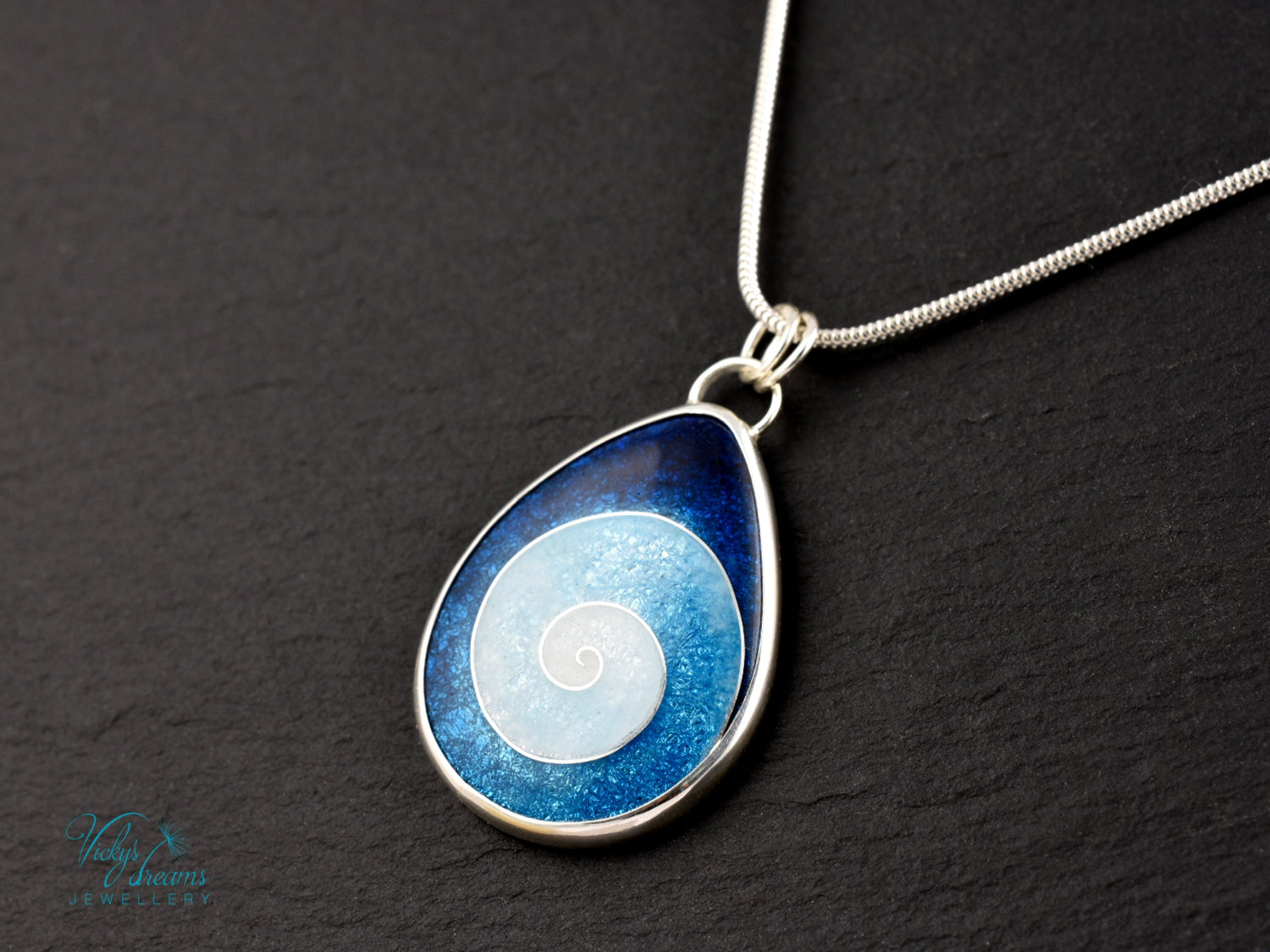 Handmade cloisonné enamel spiral pendant in blue and white, set in sterling silver