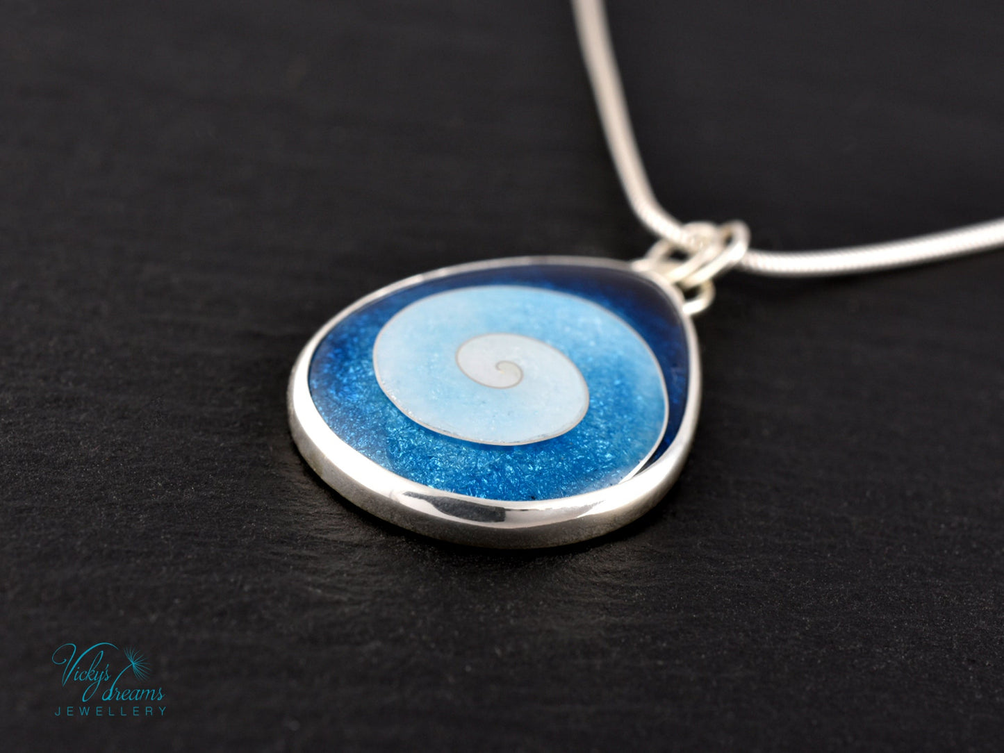 Handmade cloisonné enamel spiral pendant in blue and white, set in sterling silver