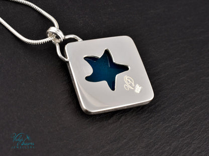 Handmade cloisonné enamel starfish pendant in ocean blue and ivory, set in sterling silver