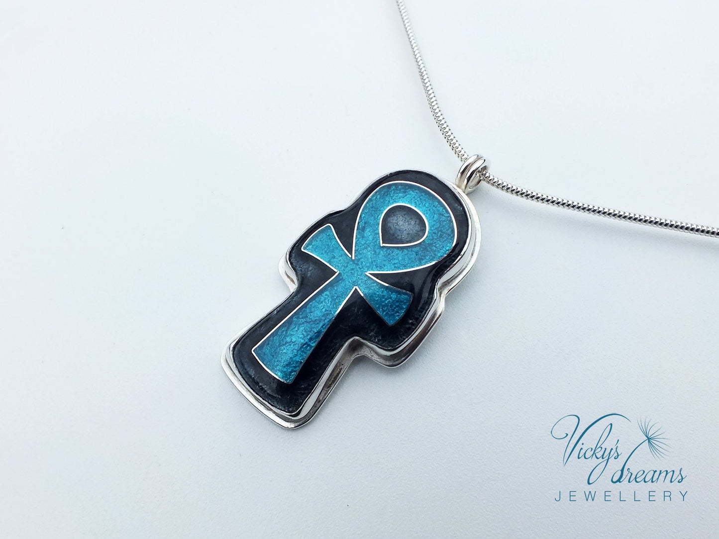 Handmade sterling silver Ankh pendant with colorful cloisonné enamel details.