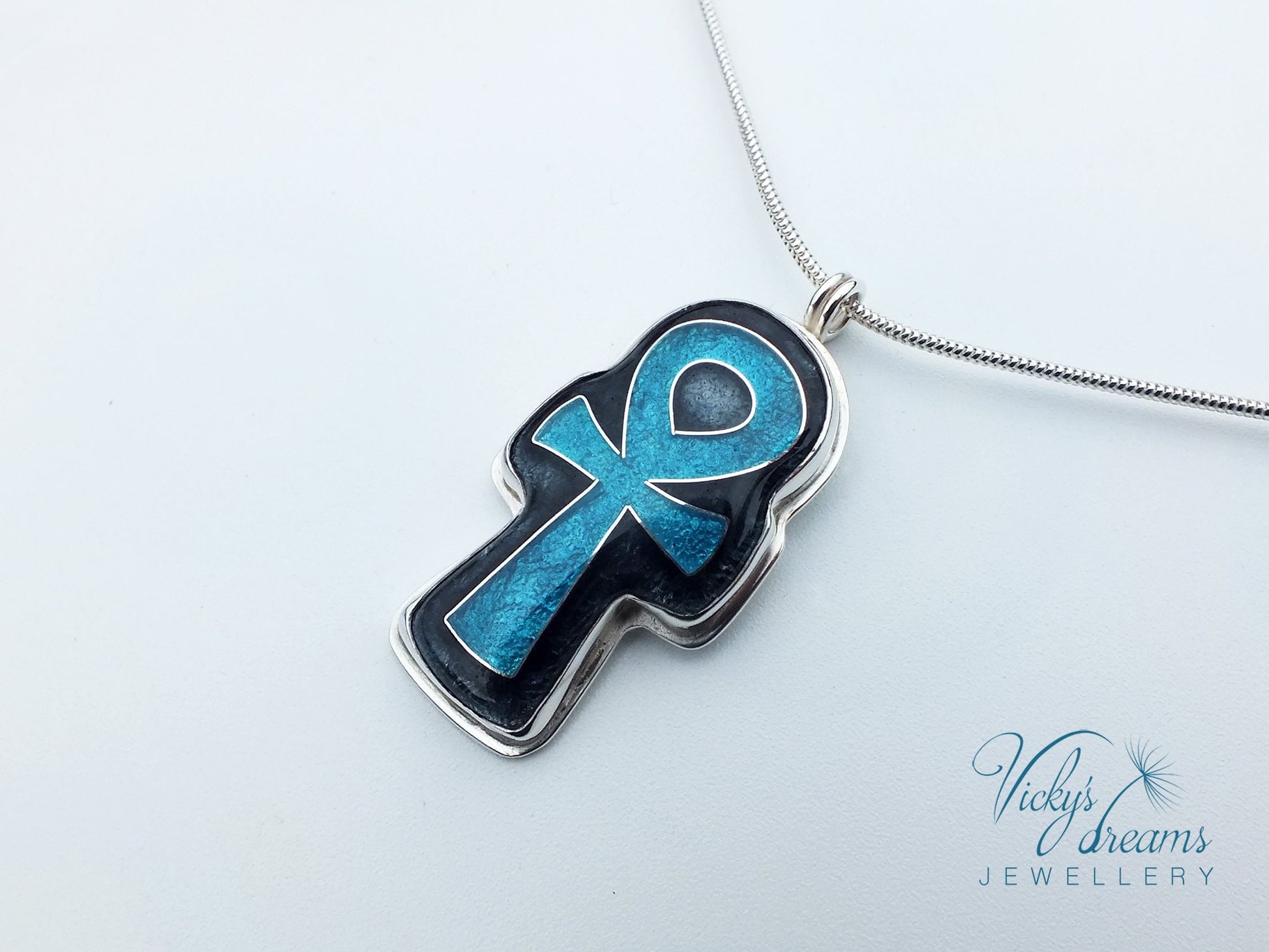 Handmade sterling silver Ankh pendant with colorful cloisonné enamel details.